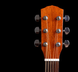Top of guitar neck over black background