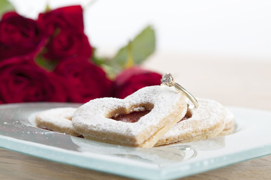 Gold engagement ring and shortbread hearts