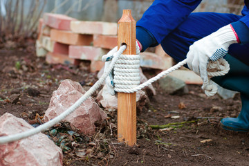 Hands decorating pale of fence