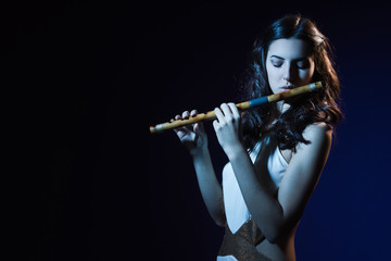 Sensuality brunette plays a wooden flute © Demian
