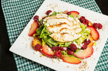 Chicken salad with plums and raspberries