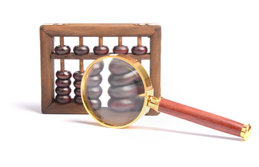 Chinese abacus and Magnifying glass,business concept