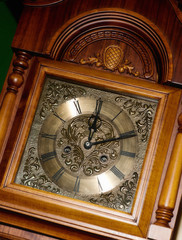 old clock face with roman numerals in wooden case