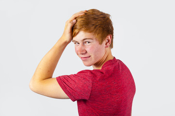 cute boy with red hair in studio