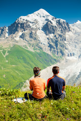 Fototapeta premium Hiker take a rest during hiking in Caucasus mountains, Georgia