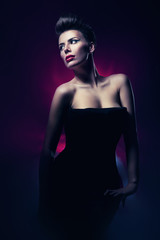 woman with red lips in dark magenta light