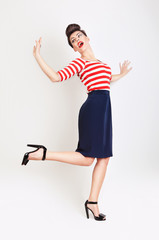 cute jumping woman with red lips in t-shirt and skirt