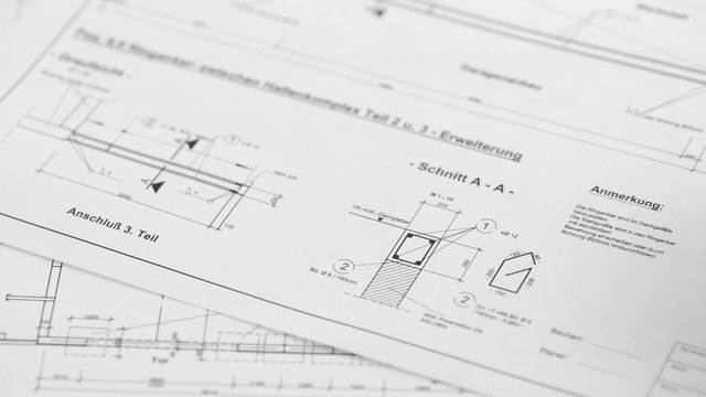 Architectural drawing blueprint with calculator and pen