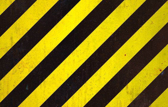 Black and yellow "under construction" sign over a grunge texture