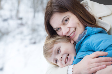 Mother and toddler son looking out train window outside