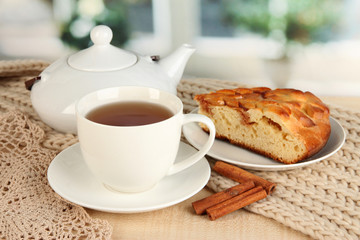 cup of tea with scarf on table in room