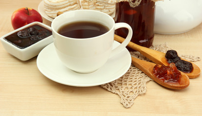 light breakfast with tea and homemade jam, on wooden table