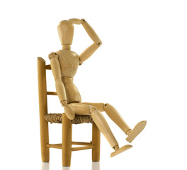 wooden puppet on chair