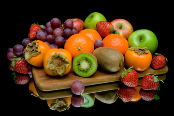 still life of fruit on a black background