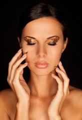 Fototapeta na wymiar tanned woman with long acrylic leopard nails and makeup