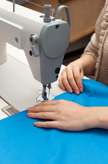 Naklejka premium work at the sewing machine