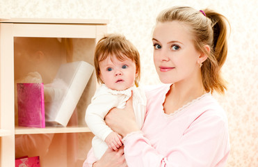 young mother and baby daughter at home