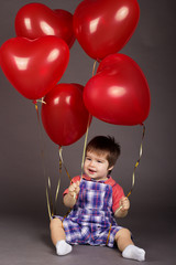 Fototapeta na wymiar Little baby boy with pink balloons. Valentines day