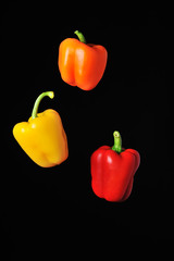 Three peppers on black