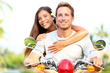 Happy young couple in love on scooter