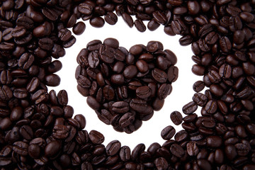 Coffee beans in heart shape isolated on white background
