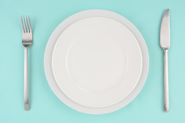 White dishes on aqua tablecloth
