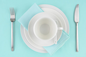 White dishes on aqua tablecloth