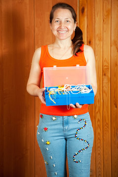 Mature woman  shows beaded jeans