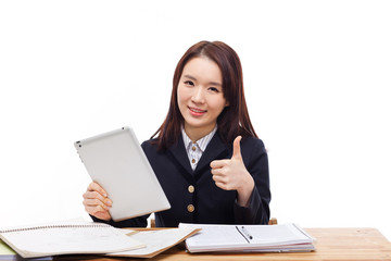 Young Asian student girl using tablet PC