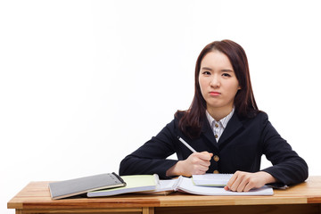 Young Asian student having trouble on desk.