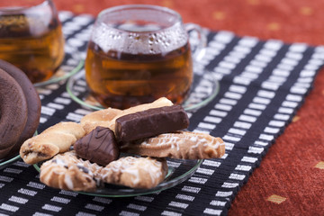 Two cups of tea with two plates with cookies
