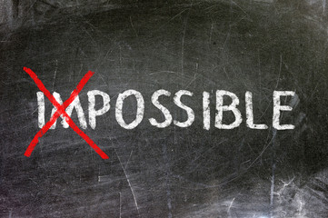 Impossible handwritten with white chalk on a blackboard.