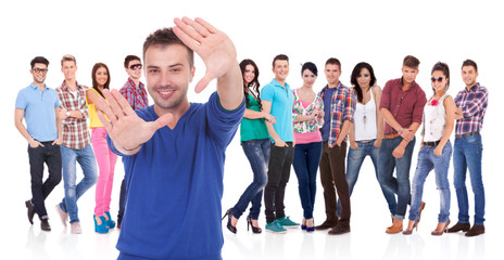 Fototapeta premium man making a hand frame in front of his team