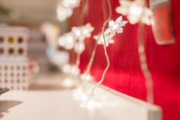 Set of small lamps in form of snowflakes on hangs on red wall in