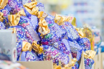 Christmas bags and boxes with candy sweets gifts in supermarket