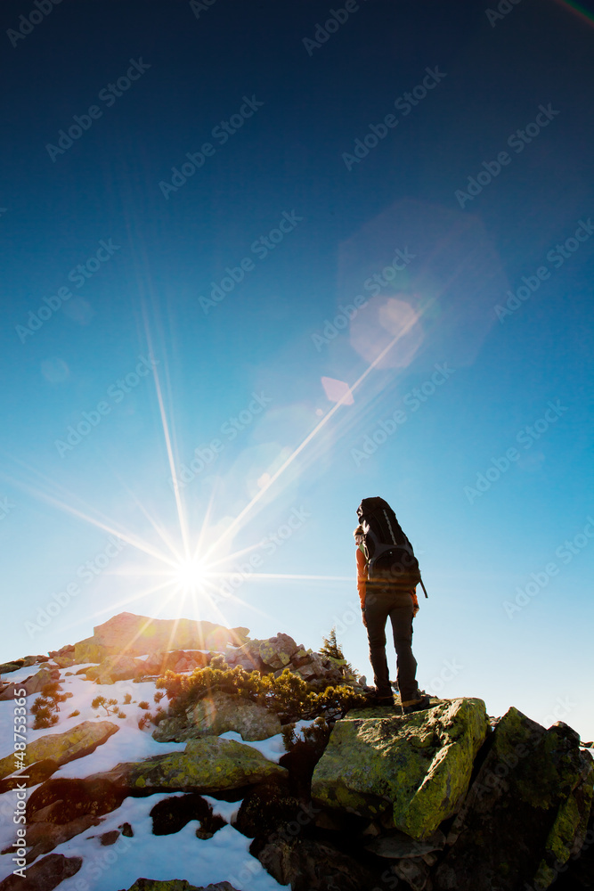 Wall mural Hiker walking in autumn mountains