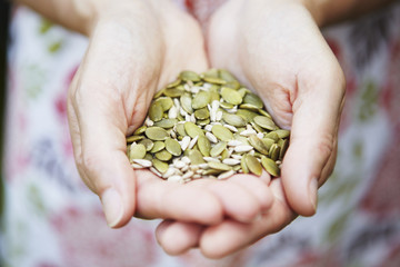 Woman Holding A Handful Of Healthy Seeds