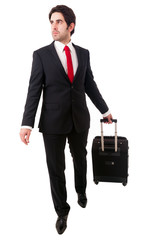 Young business man walking on white background with his travel b