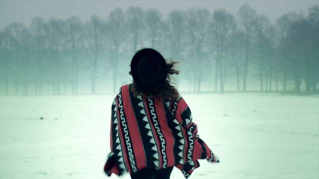 Latin woman running in the snow