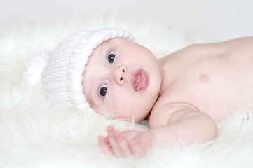 The baby in a white knitted hat