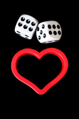 Dices and  heart symbol on a black background