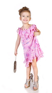 Cute little girl in big shoes and dress isolated