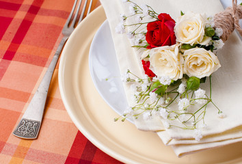 Festive table setting with flowers and vintage crockery