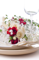 table setting with roses in bright colors and vintage crockery