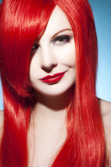 Beautiful woman portrait with glossy red hair