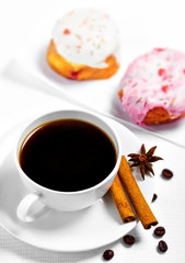 Cup of coffee and sweets on white background