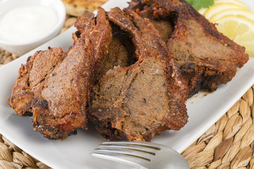 Grilled Tikka Lamb Chops with naan, lemon wedges and raita