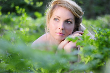beautiful girl in wood amongst green sheet