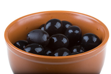 Olives black watered with olive oil in a bowl isolated on a whit