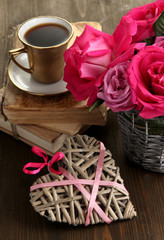 Beautiful pink roses in vase on wooden table close-up